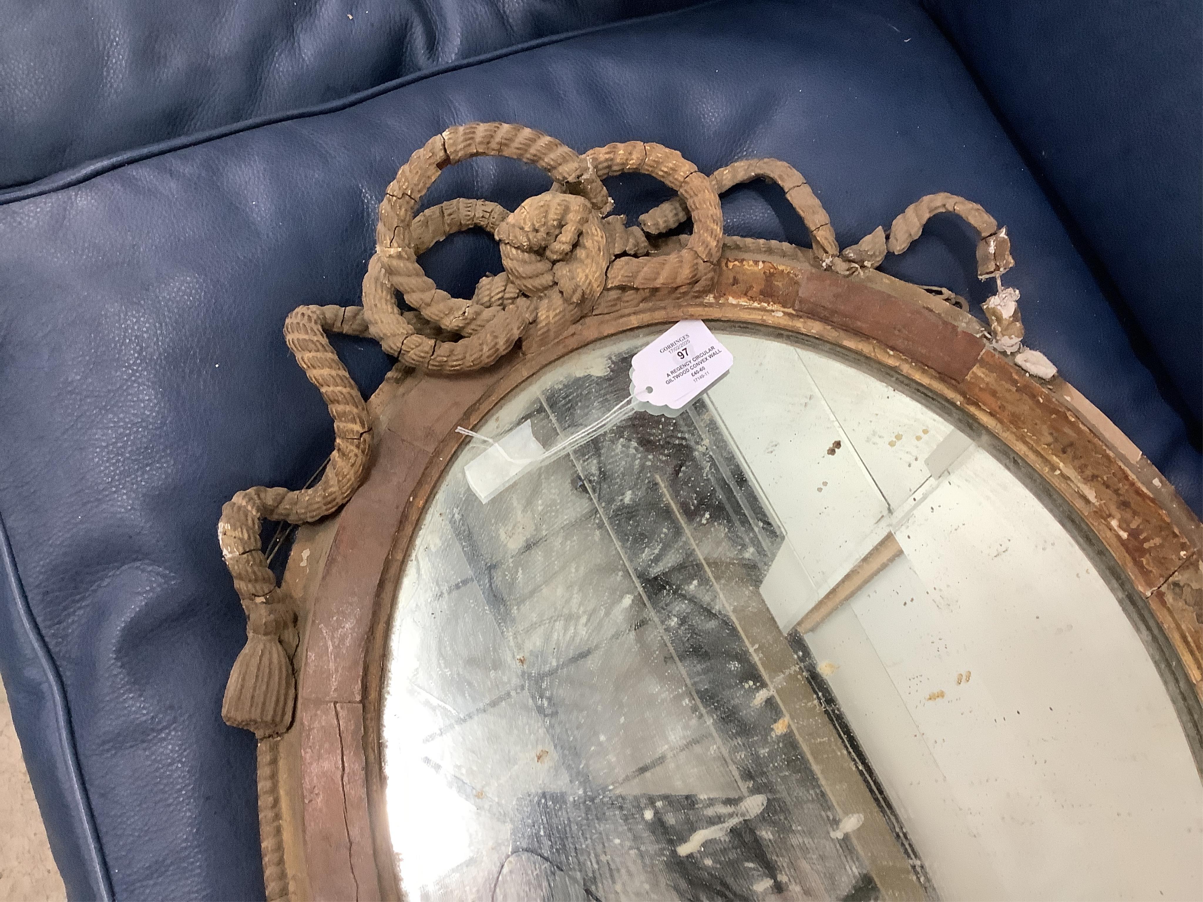 A Regency circular giltwood convex wall mirror with lion pediment, diameter 65cm a Regency convex mirror frame and Victorian girandole. Condition - poor